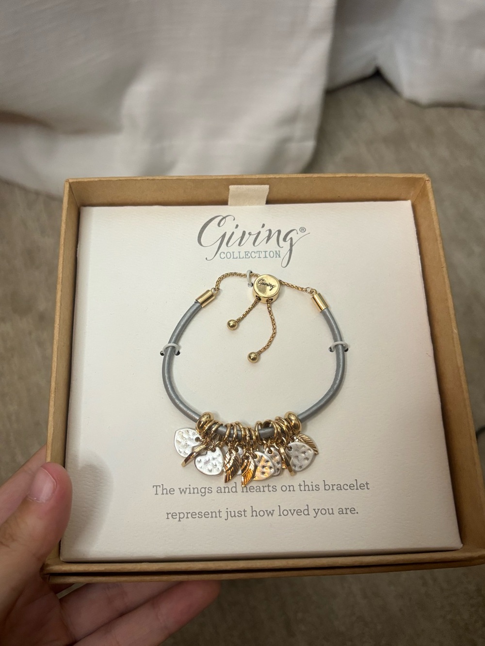 Demdaco Gray Cord Bracelet with Gold and Silver Heart & Wing Charms